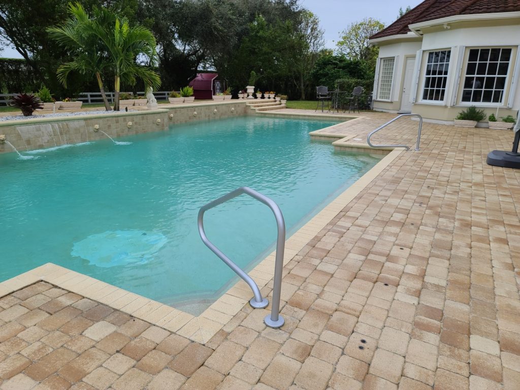 Brick paver installation around pool in Boca Raton